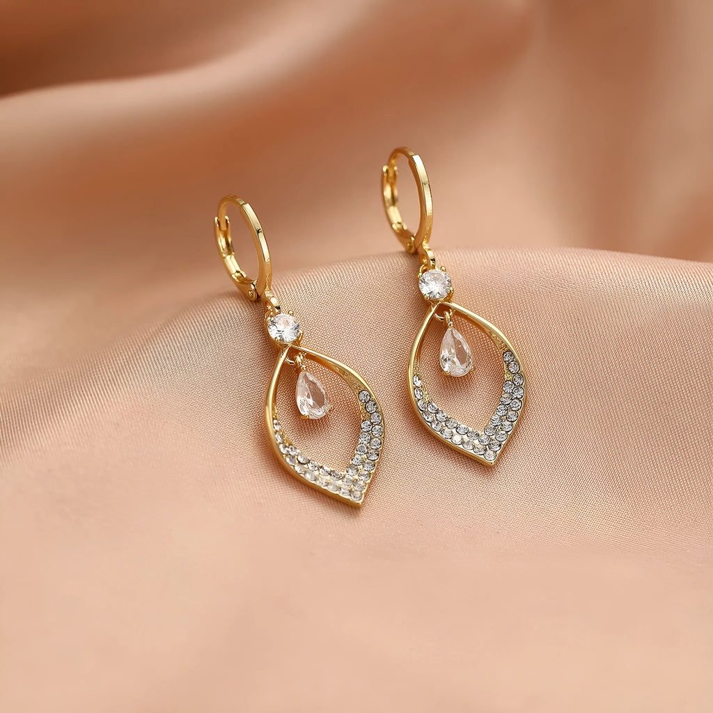 Gold zircon teardrop tassel earrings with electroplated copper construction.