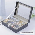 Grey leather watch storage box with transparent dustproof lid showing multiple watch slots inside