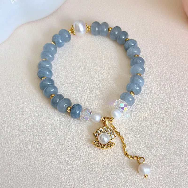 Handmade bracelet with a natural blue-green aquamarine pearl shell on an adjustable band.