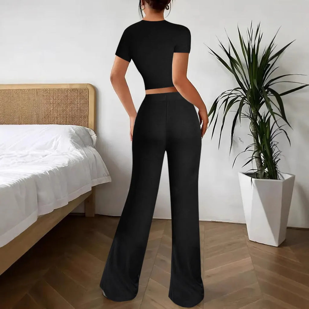 Black women's polyester tracksuit set with short sleeve top and high-waist trousers.
