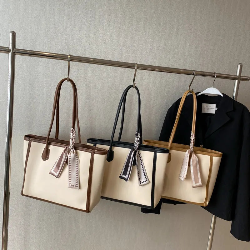Soft PU leather square tote shoulder bag in black showing open outer pocket and internal phone compartment.
