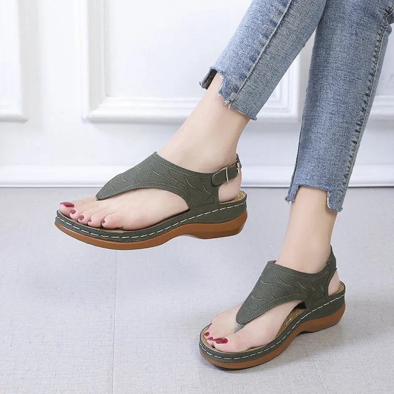 Women's casual wedge heel flip flop sandals with an adjustable buckle strap in a solid colour.