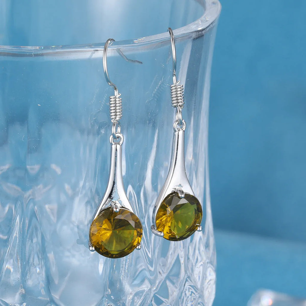 A pair of simple olive green drop-shaped earrings with a retro style on a white background.
