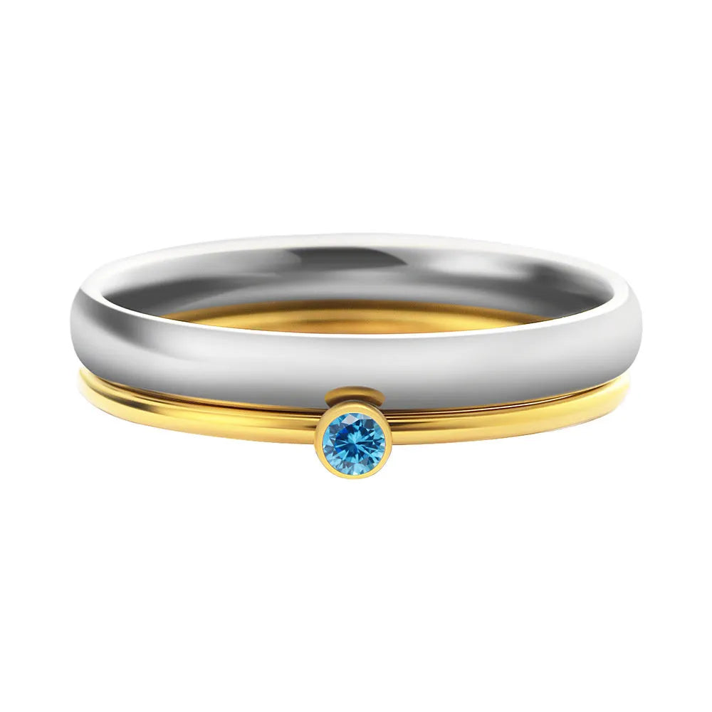 A geometric engraved titanium steel ring with a December birthstone, showcasing gold-tone and steel lettering accents.