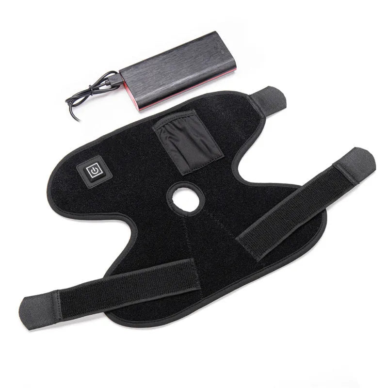 Black fabric ankle support with red light and heating therapy, USB cable, on a flat surface