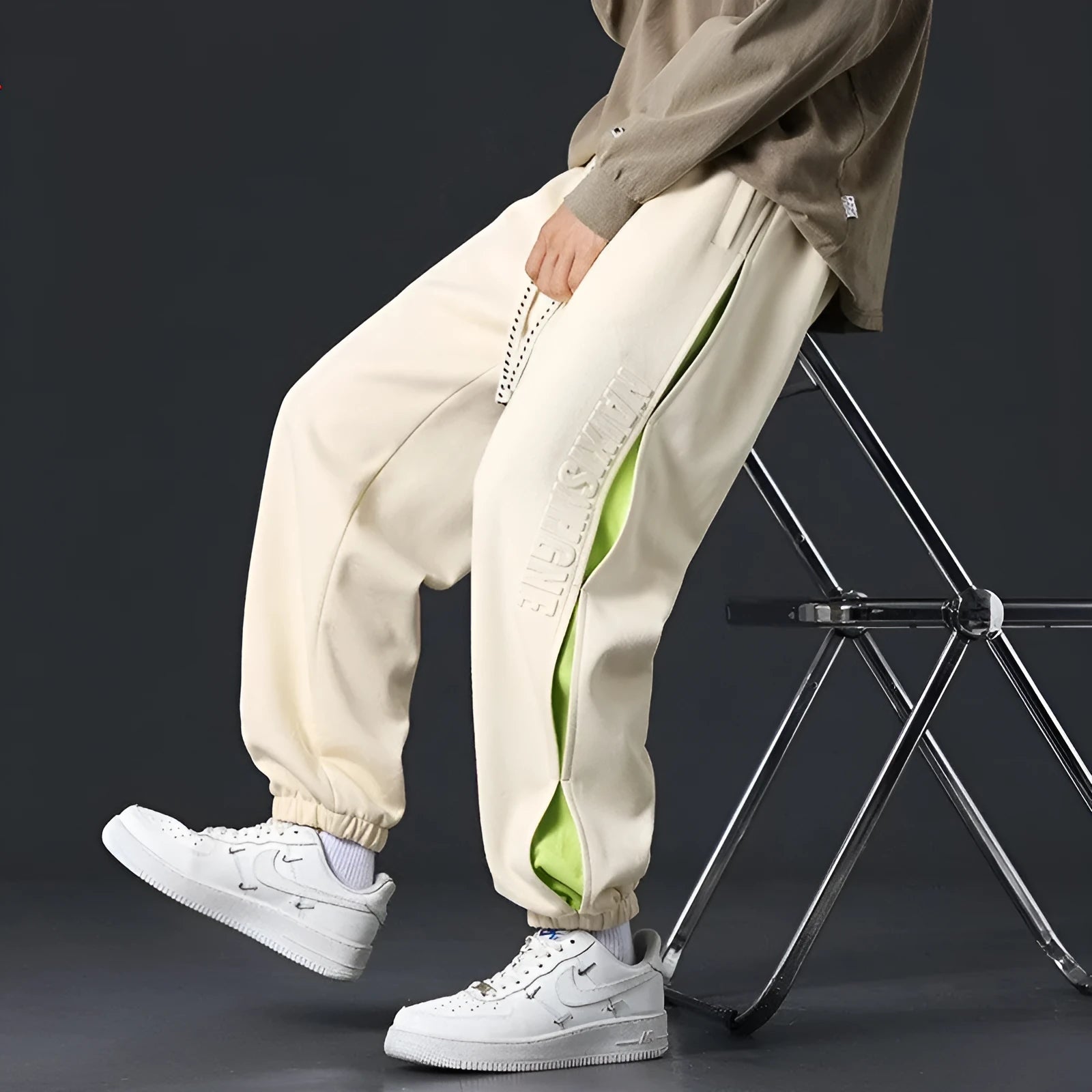 Men's loose cotton trousers with elasticated ankle bands and collage stitching details in khaki colour