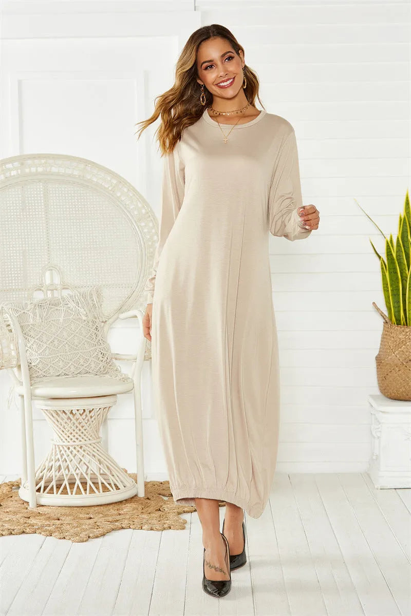 A loose long lantern dress with a lace-up crew neck, shown in grey.