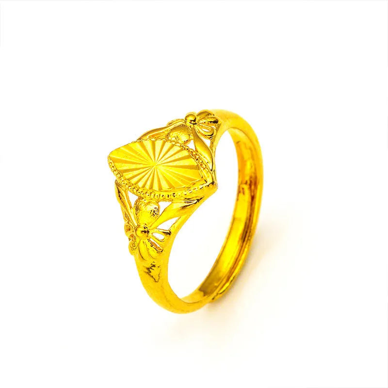 Gold openwork geometric flower ring with a textured alluvial pattern on a brass base.