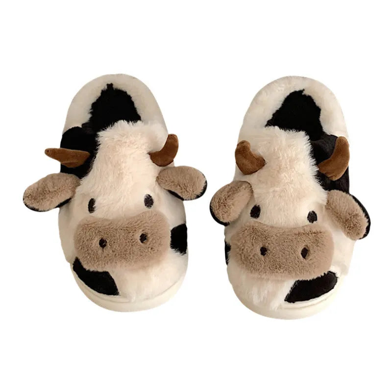 White cow print faux fur slippers for women with a non-slip textured sole.