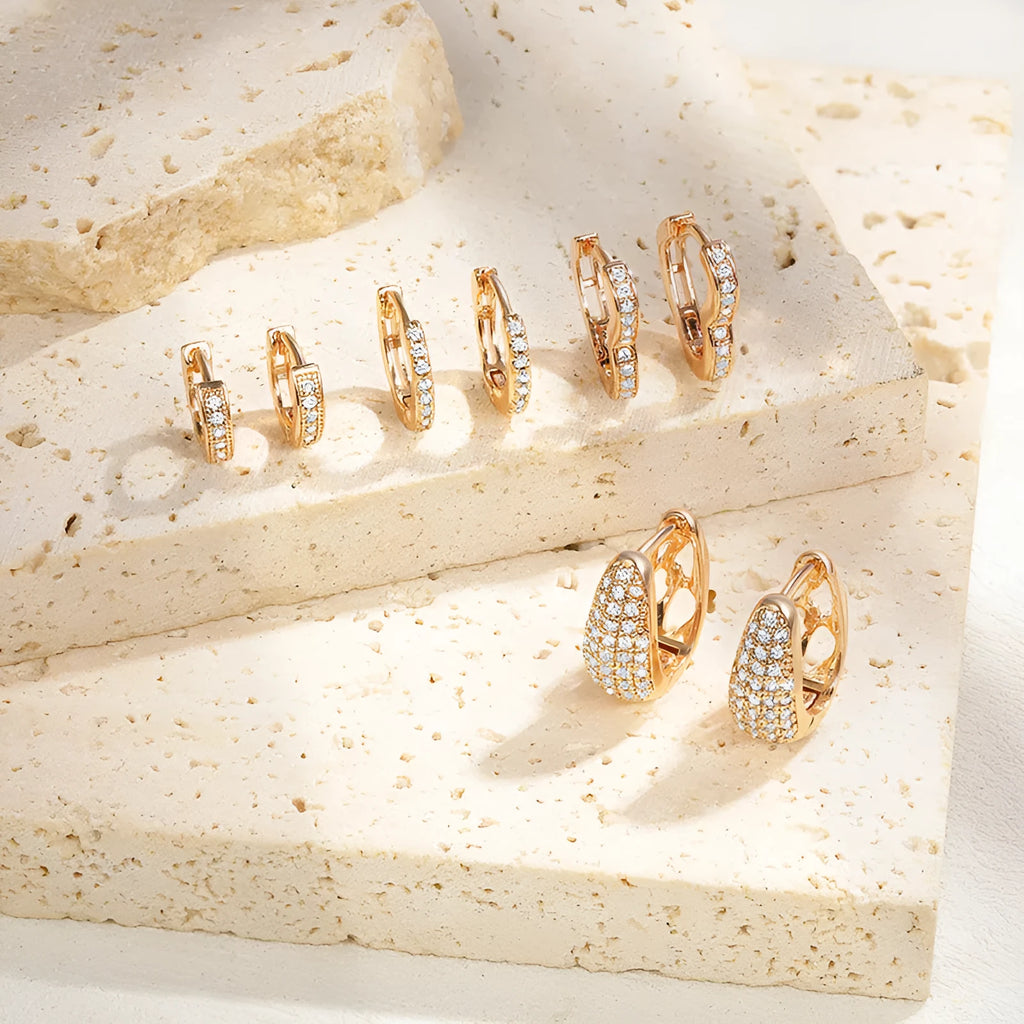 Brass gold plated heart-shaped zircon clip earrings with gang drill detailing showing four colour options