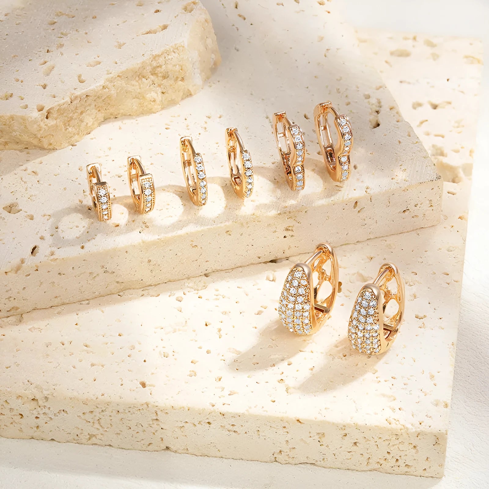 Brass gold plated heart-shaped zircon clip earrings with gang drill detailing showing four colour options