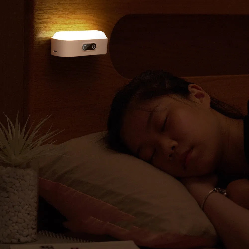 White USB rechargeable magnetic LED night light with touch controls on a metal study cabinet.