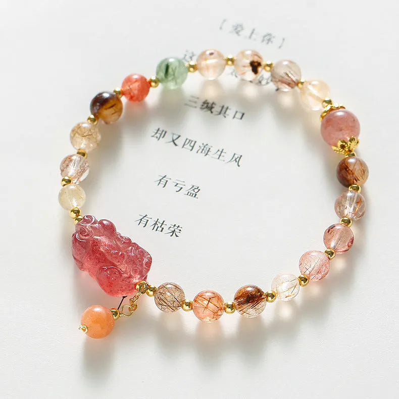Women's strawberry quartz crystal bracelet with copper construction and pearl detailing in Chinese style design.