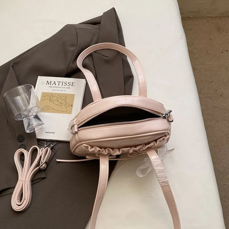 PU leather ladies shoulder bag with bandage bow design and decorative sewing thread in milky white colour
