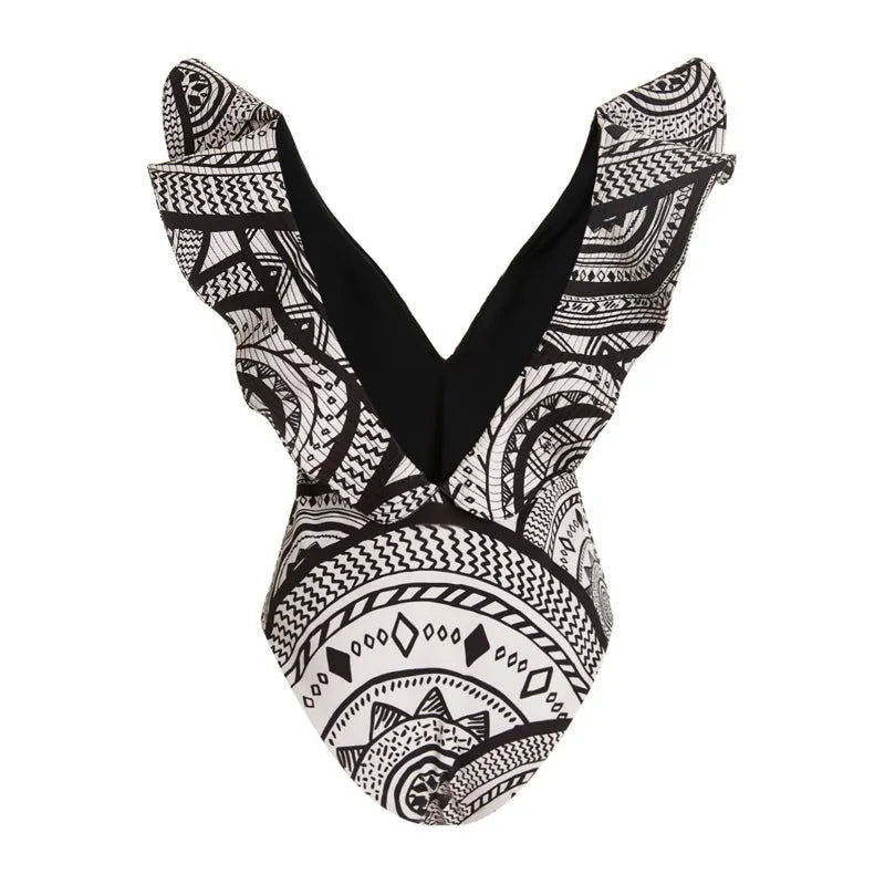Women's deep V-neck one-piece swimsuit with vintage floral print and matching black wrap skirt.