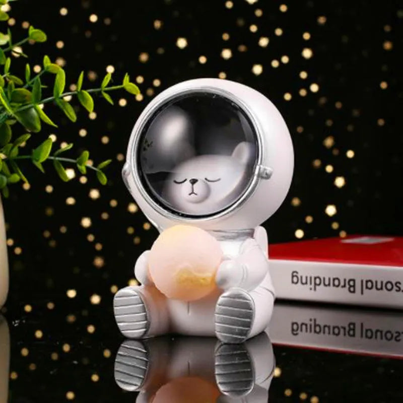 Resin animal night light in bear design with starry sky LED glow on a table.