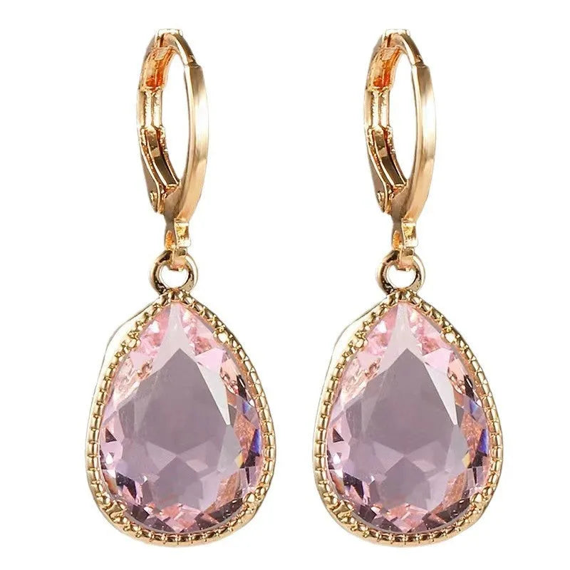 Geometric copper-coloured glass water drop earrings with a Saturn design element.