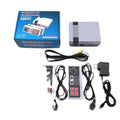 Compact black NES 8-bit retro game console with two rectangular controllers on a grey surface.