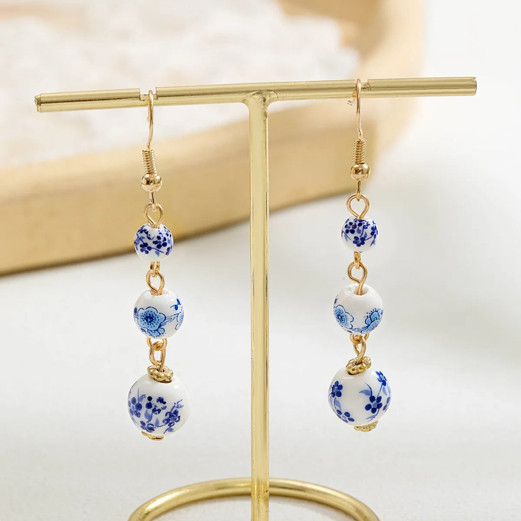 Blue and white porcelain ceramic bead earrings with geometric alloy elements in Chinese style design