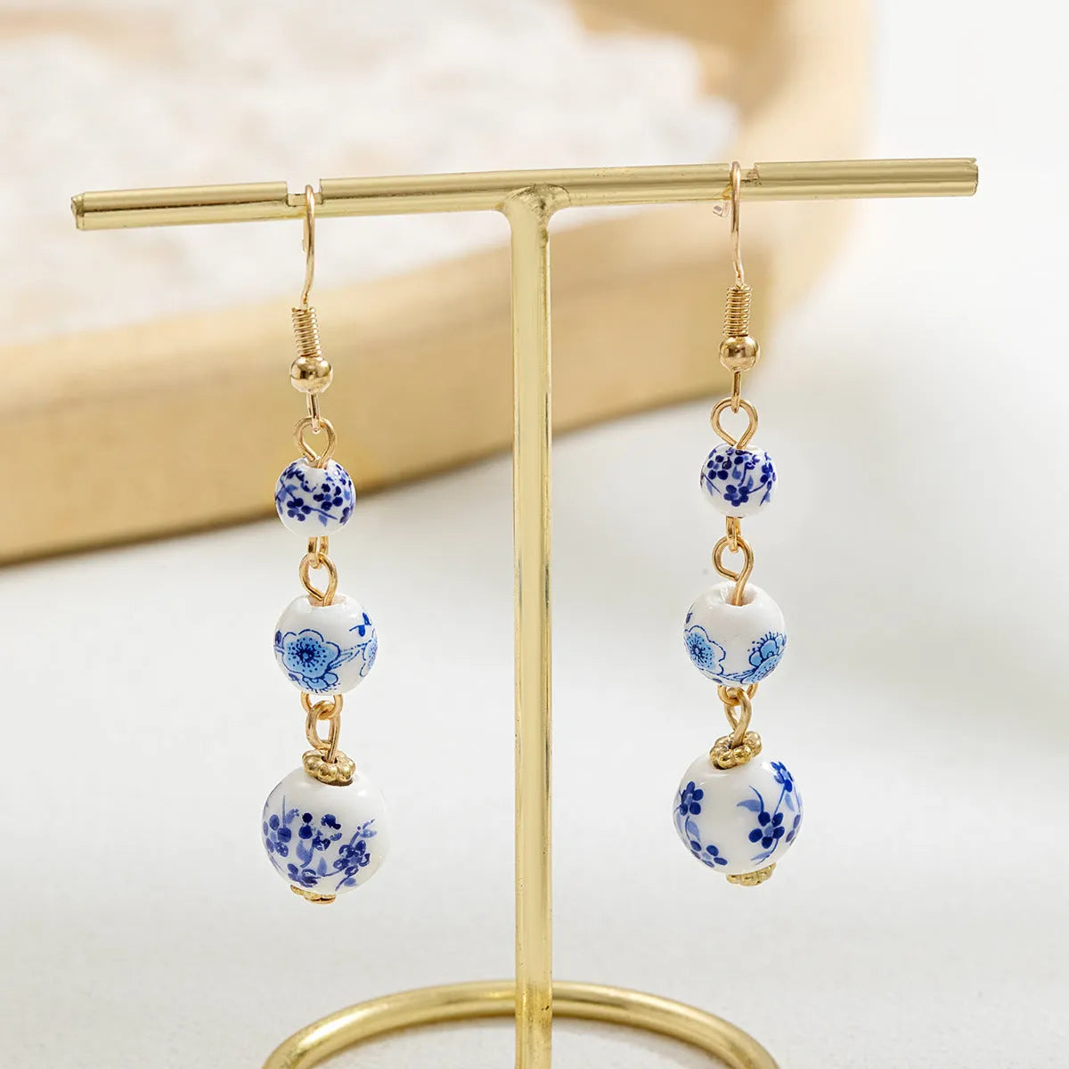 Blue and white porcelain ceramic bead earrings with geometric alloy elements in Chinese style design