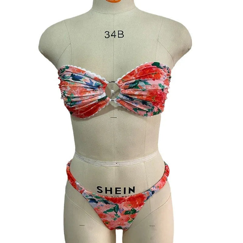Women's floral print bikini set with lace trim on a backless tube top and matching briefs.