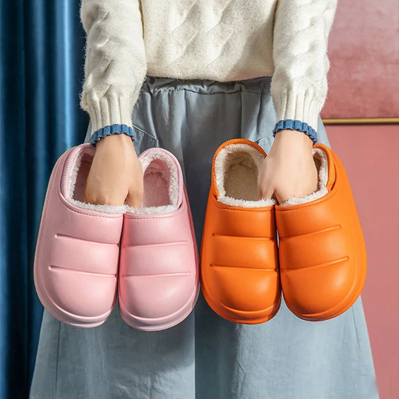 A pair of waterproof EVA couple slippers in green with a plush lining and non-slip sole.