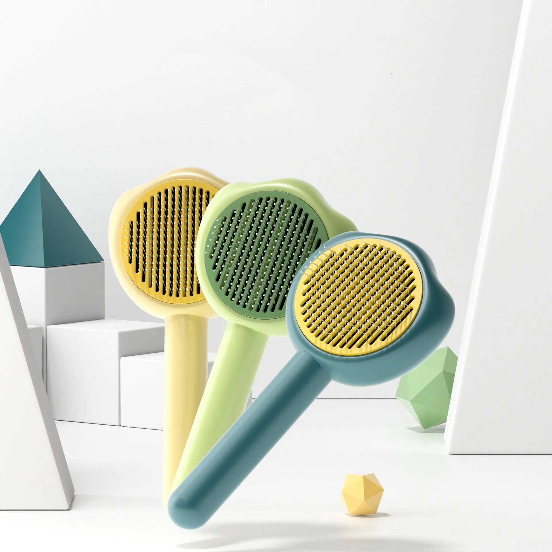 Blue plastic cat grooming comb with retractable needle teeth and a cute handle on a white background